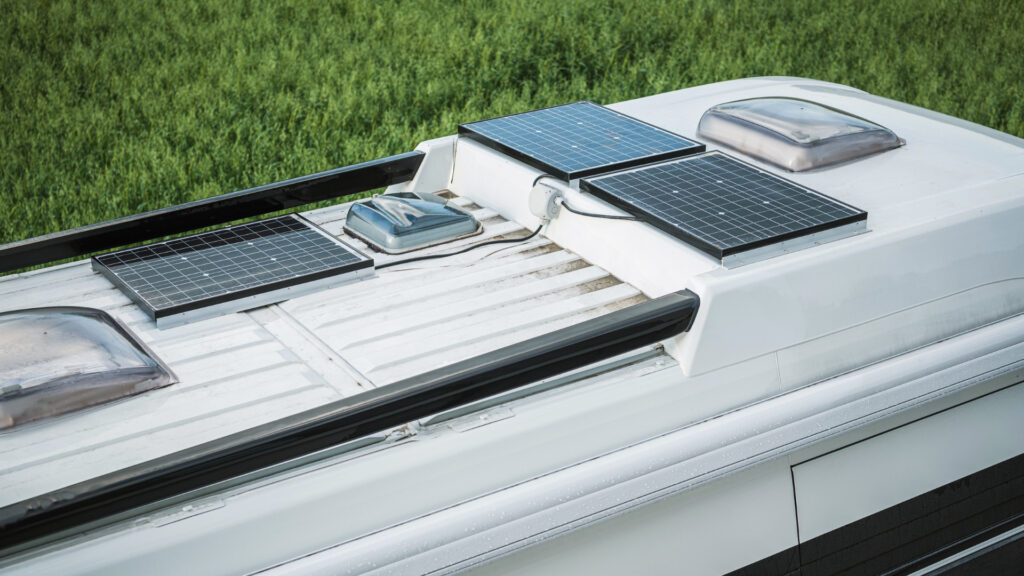 The roof of an RV with a solar panel kit installed and there is room for more panels.