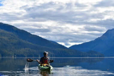 A kayaker on the ocean in between Windfall and Admiralty Islands in the Tongass National Forest in Alaska