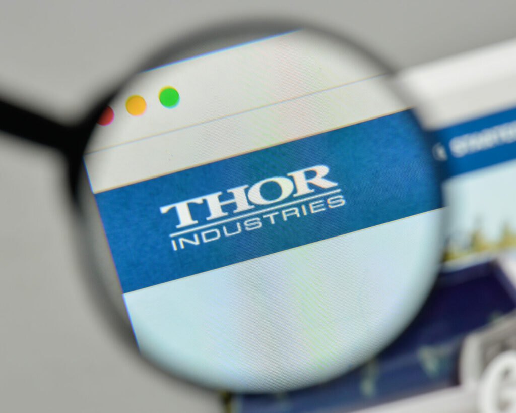 A magnifying glass over a website that shows Thor Industries magnified