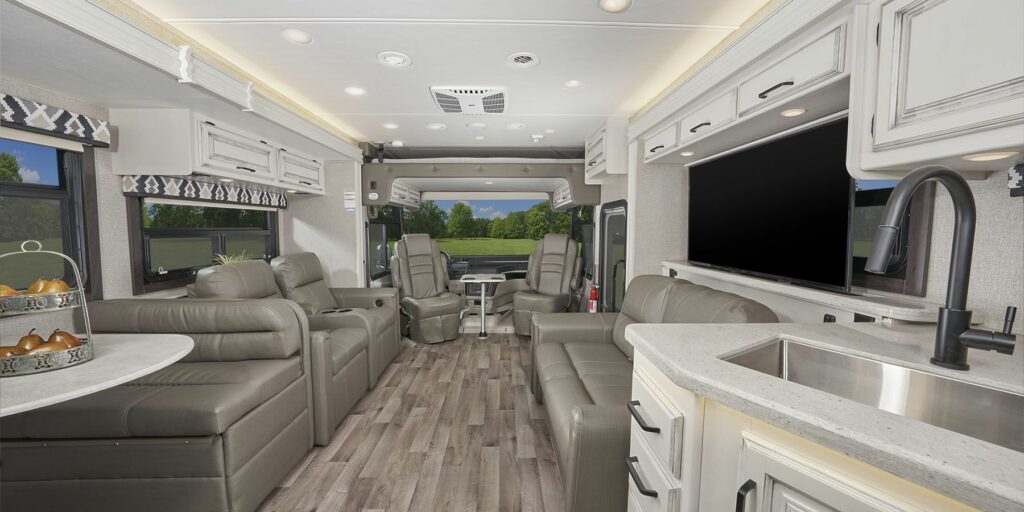 Interior shot of a Jayco RV Class A with white walls and gray couches 