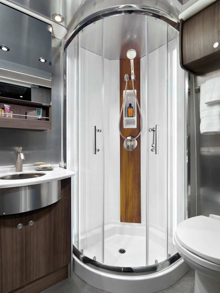 The residential-style bathroom in the 2020 Airstream Atlas with stand-up shower and wardrobe.