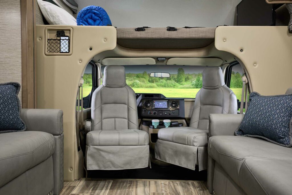 An interior view of the captain chairs turned around to face the living space in a Thor Outlaw, which makes our list of best class C RVs for winter.