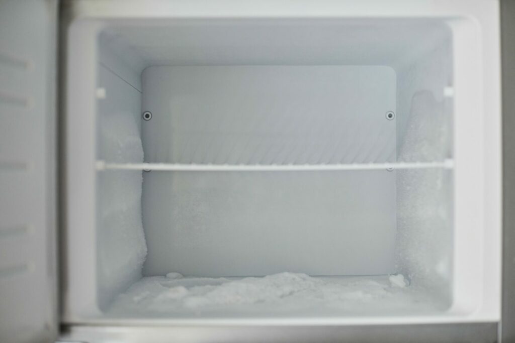 Inside of RV fridge with some ice build up.