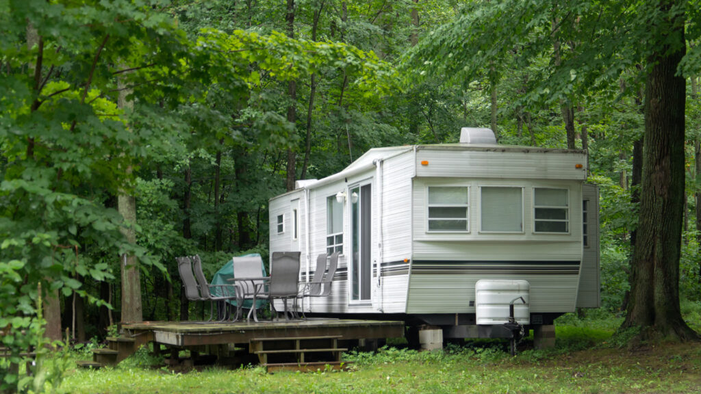 An RV can make a permanent living space on private land with some simple modifications like adding a deck and a sewage dump.