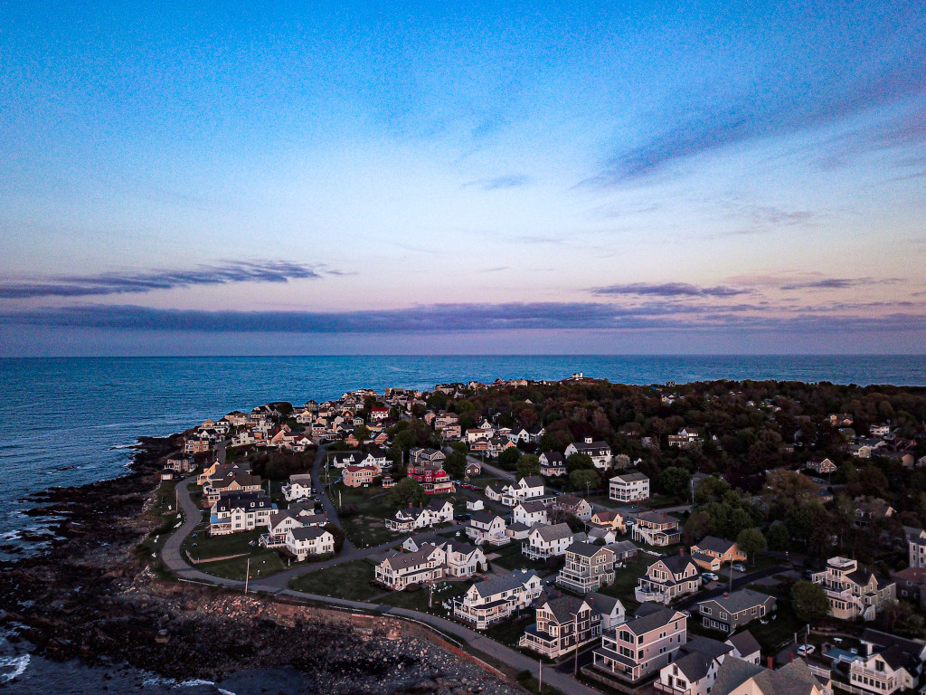 Aerial view of the town of York, Maine where homes dot the ocean coastline.