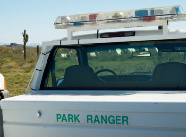 A park ranger truck with sirens that look like cop car sirens on top.