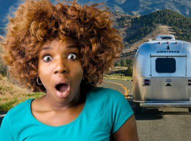 A woman's eyes are wide and mouth is ajar in shock at the price of an Airstream