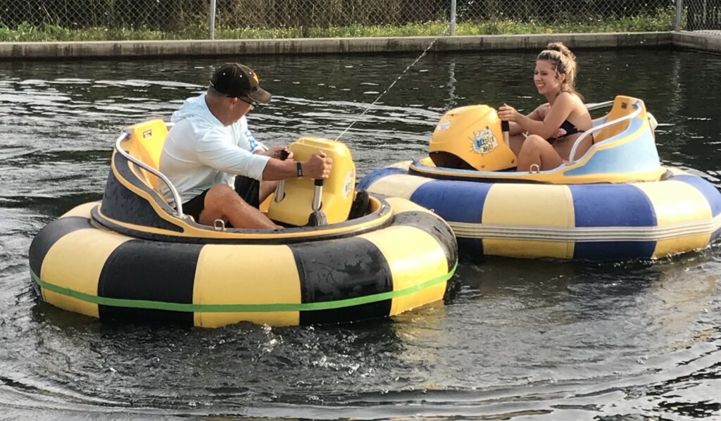 Father and daughter battle on bumper boats at a KOA campground