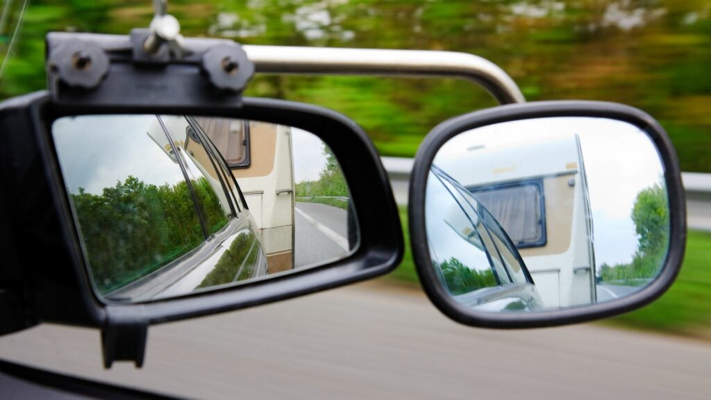 Additional towing mirrors mounted to your side mirrors are helpful when pulling an RV, but they can't show you as much as a backup camera can.