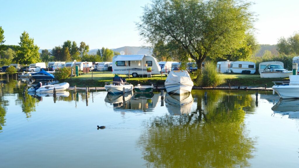 Camping at an RV resort along a river with boats in the water