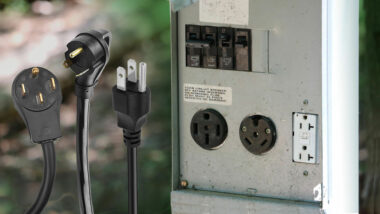 Three types of RV power cords next to an electrical box at a campground with different types of outlets.