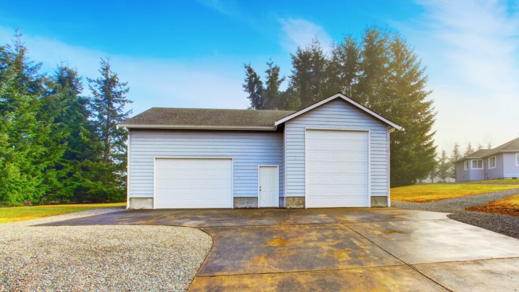 A newly built outbuilding with two garage doors, one tall enough for a big RV.