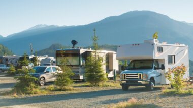 An RV park with mountains in the background.
