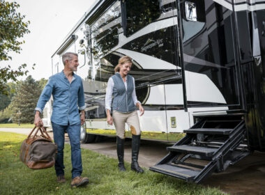 A couple walks up to the steps of their Newmar RV after a day of horse back riding