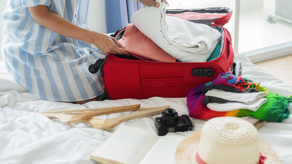 A woman packs for her upcoming RV vacation. She keeps organized with her RV Packing checklist.