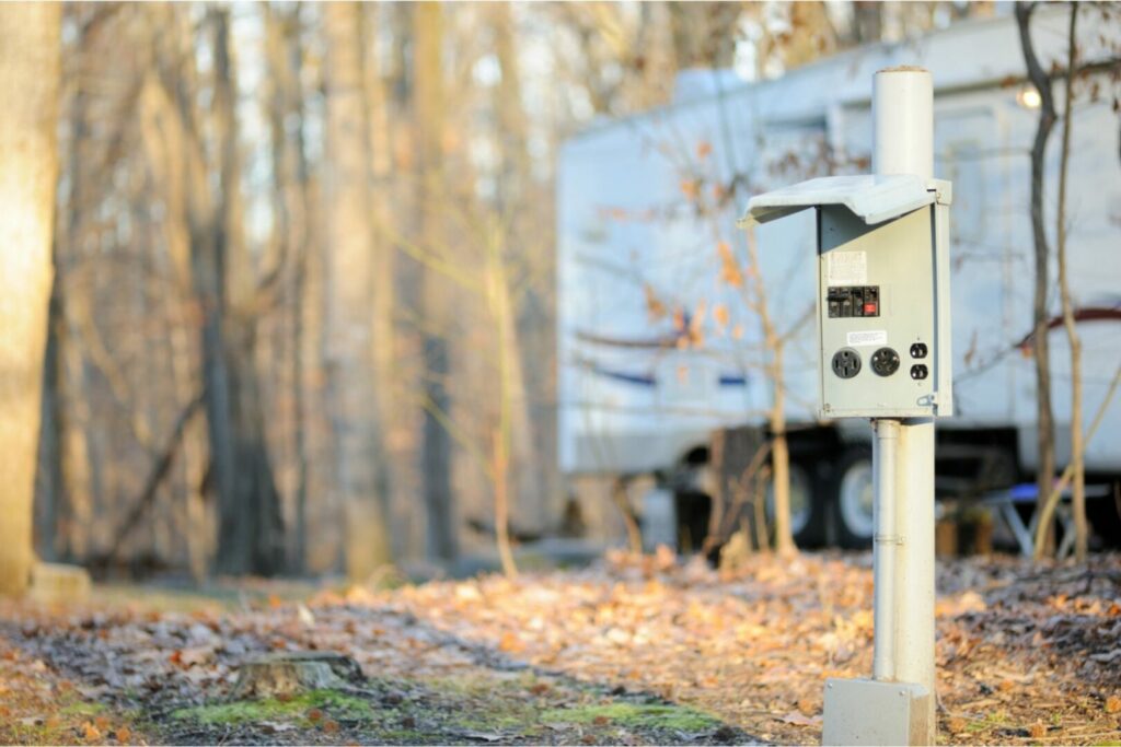 At a campground, an electrical pedestal has 30 amp and 50 amp rv plugs available for campers.