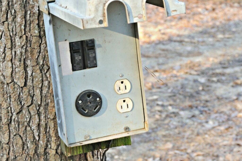 A power box at a campground has a both a 30 amp plug and a 20 amp plug.