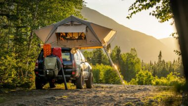 Boondocking with a car tent in the woods with a view of mountains and the sunset