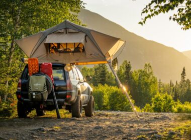Boondocking with a car tent in the woods with a view of mountains and the sunset