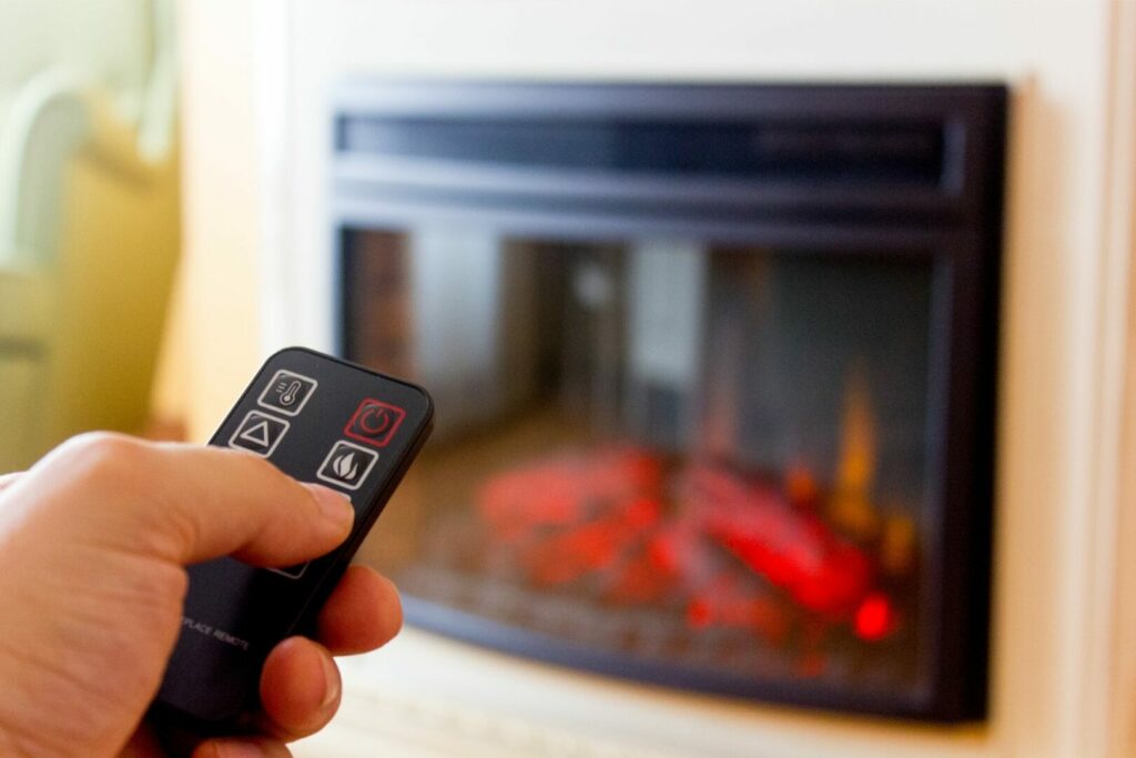 Using a remote to operate an electric RV fireplace.