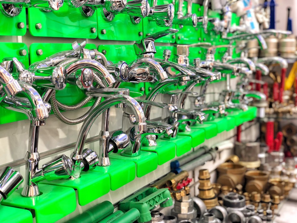 An aisle in a hardware store with faucets.
