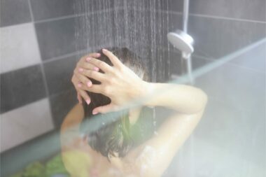 Close up of a woman enjoying a hot shower