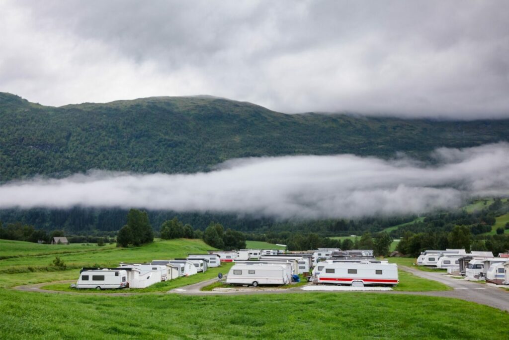 Permanent trailers parked in a valley where people enjoy stationary RV living.