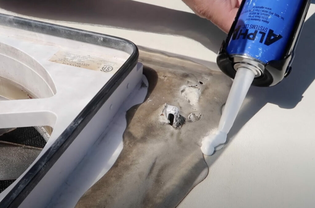 Alpha Systems RV roof sealant being added to cover old sealant around an RV fan on the roof. 