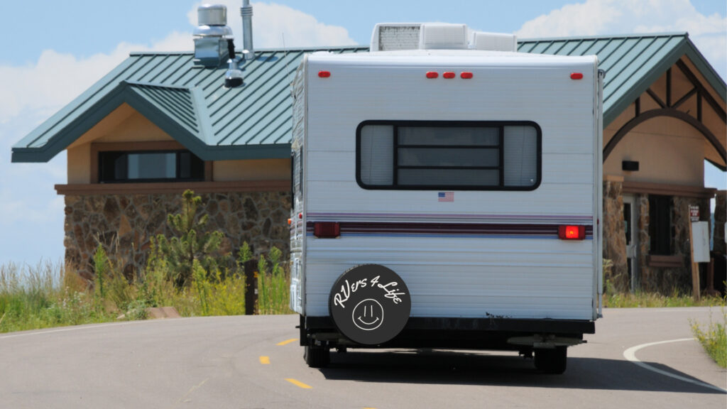 An RV with a wheel cover that shows it's name "RVers 4 life".