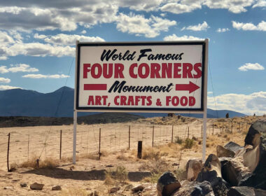 The sign is found in Shiprock, New Mexico, and it directs travelers to the Four Corners area of the Southwestern United States where four states meet: Colorado, Utah, Arizona and New Mexico.