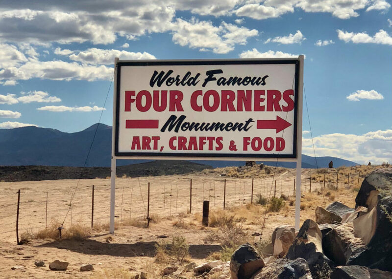The sign is found in Shiprock, New Mexico, and it directs travelers to the Four Corners area of the Southwestern United States where four states meet: Colorado, Utah, Arizona and New Mexico.