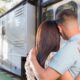 A couple hugs and looks towards a new, reliable RV they plan to purchase