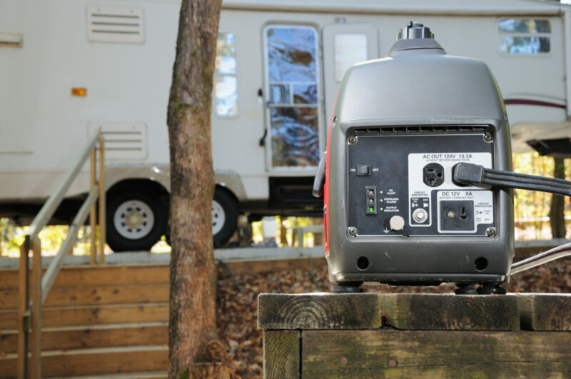 Close up of portable gasoline generator providing power for fifth wheel rv trailer in campground