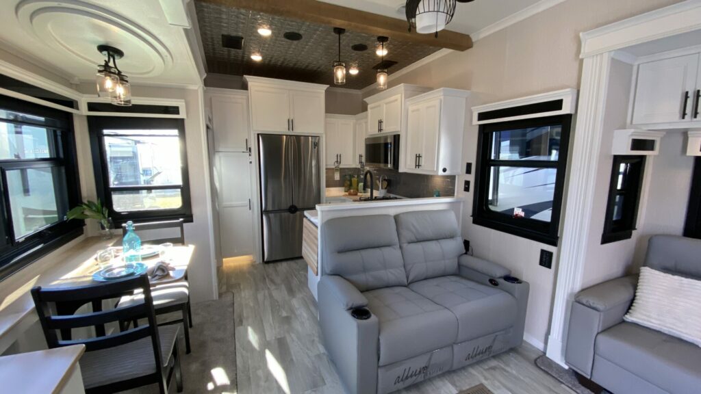 An interior shot of a fifth wheel RV with a rear kitchen. These RVs have average RV prices. 