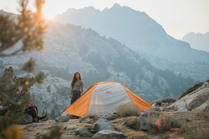 A woman tent camping in California in the mountains.