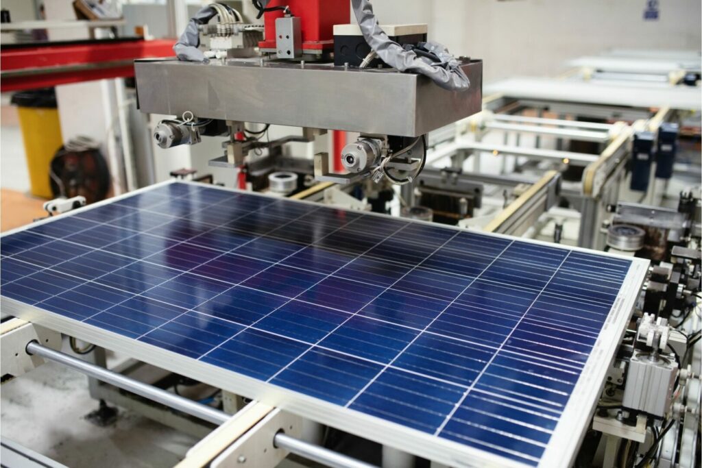 A factory that manufactures solar power equipment puts together a panel.