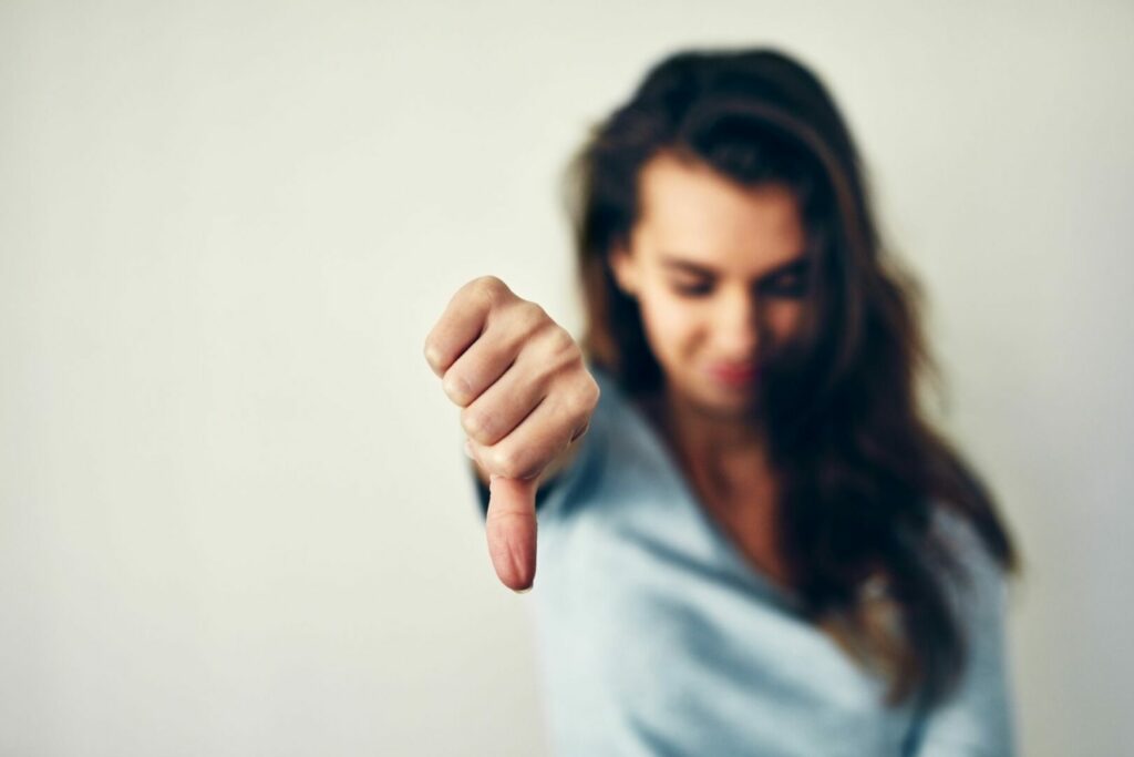 Short focus of a woman giving a thumbs down.