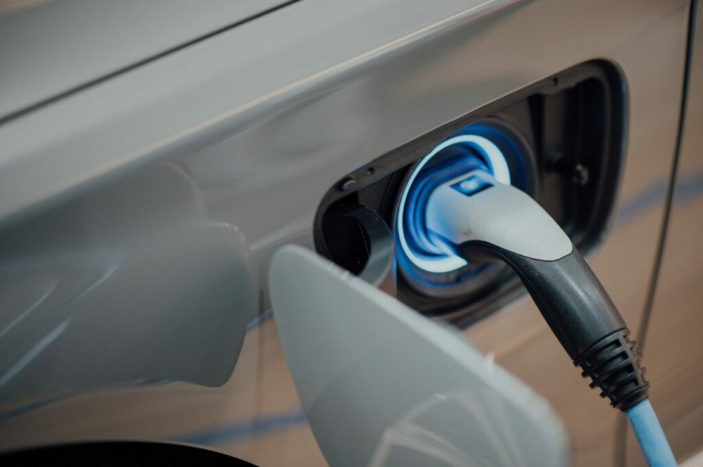 Close up of an electrical connection of a vehicle being charged.