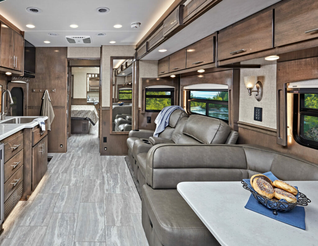 Interior of an RV Renegade Classic with wood finishes and hard surface flooring.
