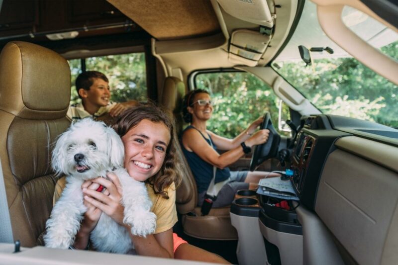 A family and their dog road tripping in an RV