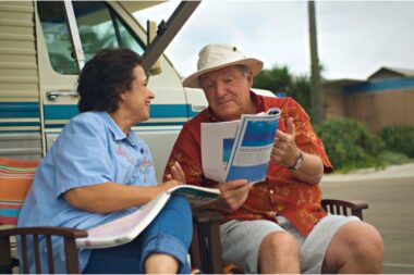 A senior couple discusses literature outside of their RV