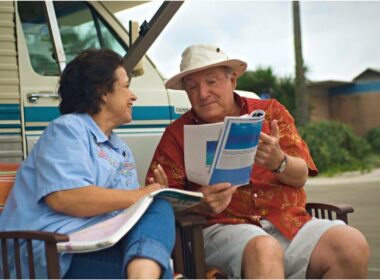 A senior couple discusses literature outside of their RV