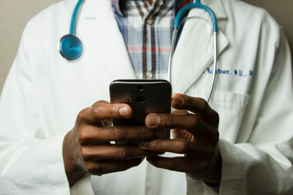 Close up of a doctor using his mobile phone