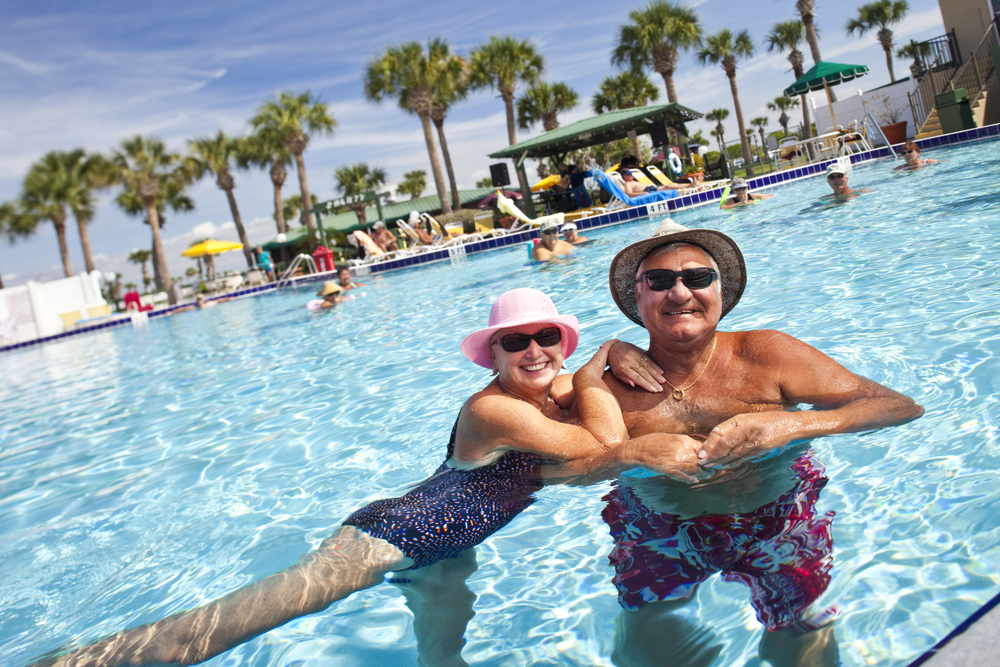 An older man and woman swimming in the pool of the KOA campground in Okeechobee Florida. 