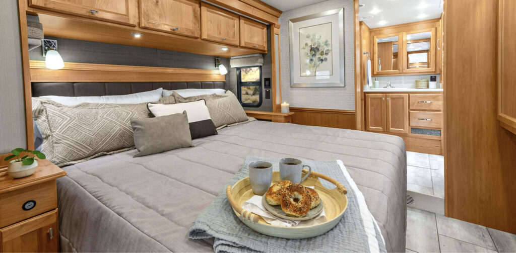 Interior shot showing the bed and rear bathroom of the Tiffin Motorhomes Allegro. 