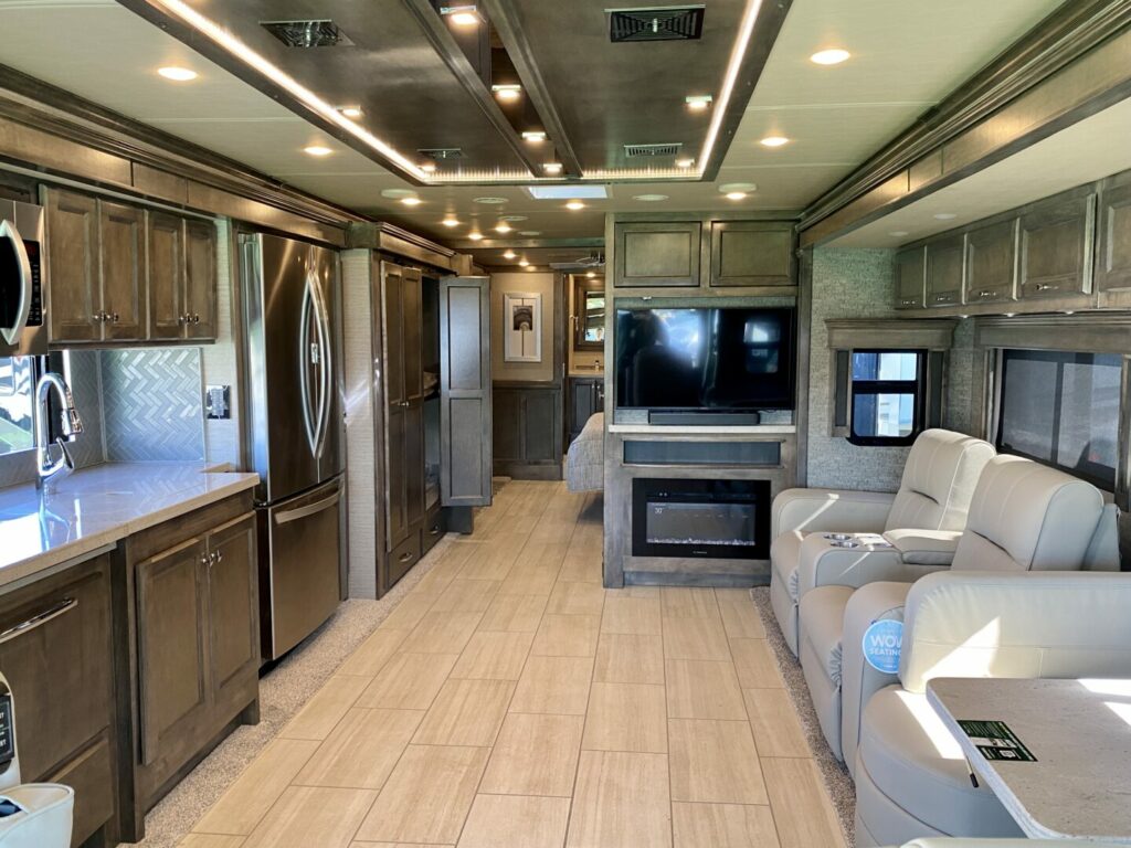 Interior shot of the living room, kitchen, and TV of a Tiffin RV.
