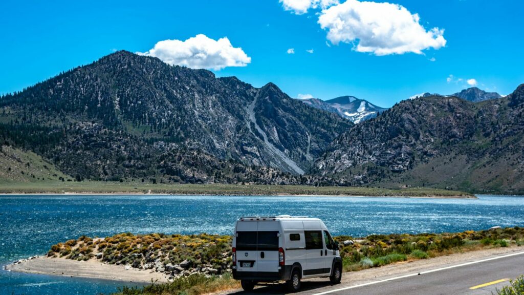 A van parked on the side of the road overlooking mountains