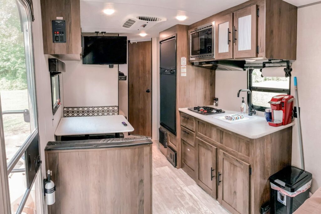 Interior shot of a travel trailer kitchen with slides extended that is available as an RV Rental in Michigan
