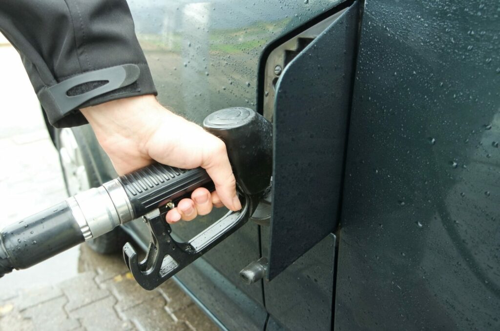 A guy filling up his vehicle with the appropriate gas for his engine, as they know what happens when you put diesel in a gas engine. 