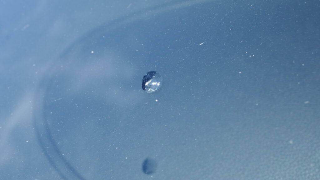 A close up shot of a chipped windshield 